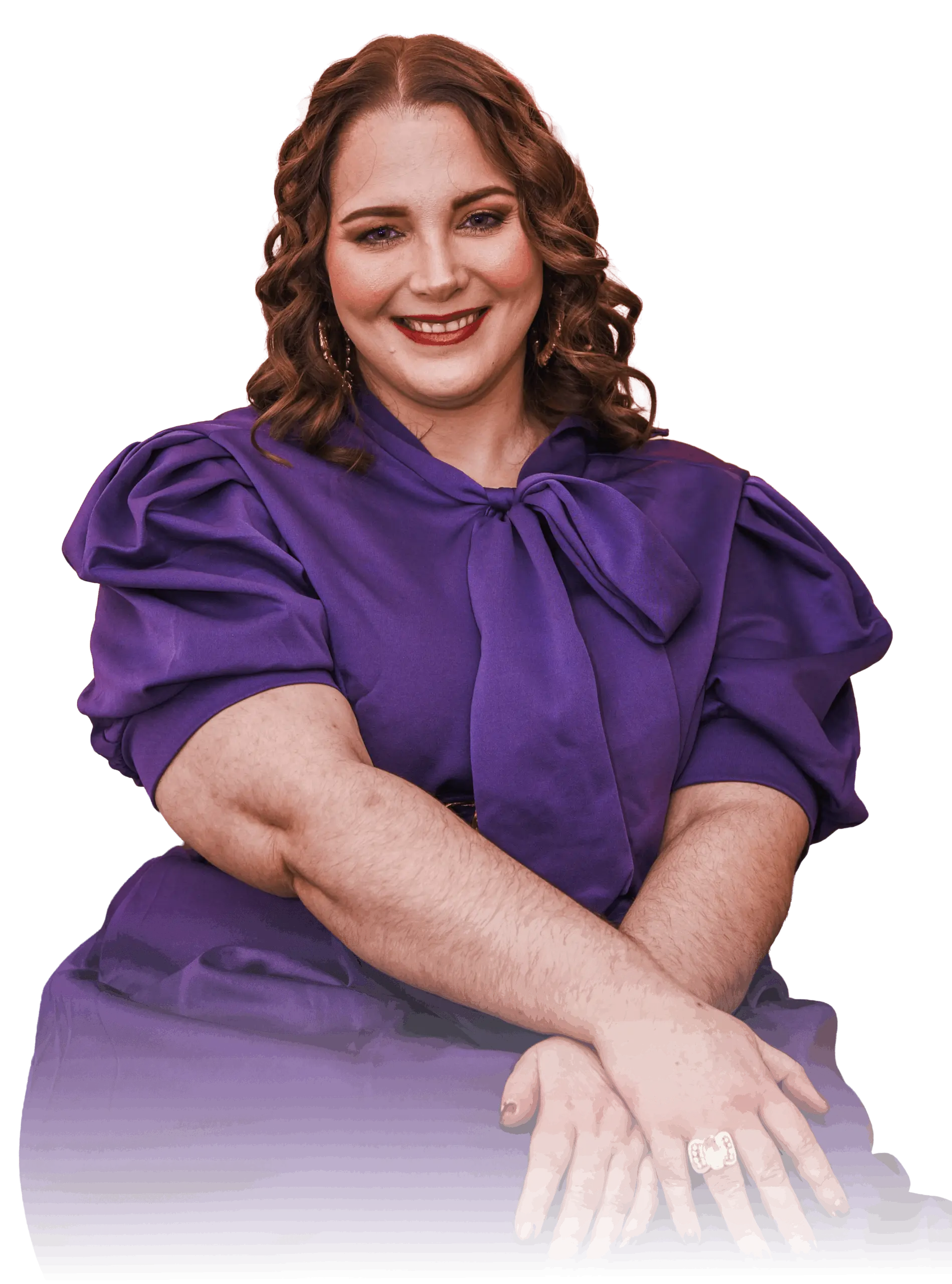 A woman with curly hair smiles warmly, wearing a purple dress with puffed sleeves and a large bow. Her hands are gently clasped in front, set against a black background.